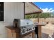 Outdoor kitchen featuring a stainless steel grill and tiled countertop at 2230 W Peralta Ave, Mesa, AZ 85202