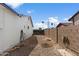 Side yard with gravel, block wall, and access gate at 2230 W Peralta Ave, Mesa, AZ 85202
