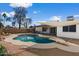 Inviting backyard featuring a pool with diving board, fire pit, and covered patio at 2230 W Peralta Ave, Mesa, AZ 85202