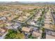 High angle aerial view of a home with a pool surrounded by desert landscape in a residential community with mountain backdrop at 22472 N 80Th Ln, Peoria, AZ 85383