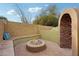 Private fire pit area with built-in seating and decorative stone surround, great for cozy evenings at 22472 N 80Th Ln, Peoria, AZ 85383