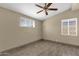 The bright bedroom features modern windows, neutral walls, wood-look floors and a ceiling fan at 2545 E Amelia Ave, Phoenix, AZ 85016