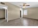 Bedroom features a ceiling fan, wood-look flooring, walk-in closet, and adjacent doorway to another room at 2545 E Amelia Ave, Phoenix, AZ 85016
