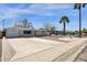 Well-kept single-story home with a long driveway, desert landscaping, and blue skies overhead at 2545 E Amelia Ave, Phoenix, AZ 85016