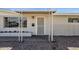 Cozy front porch with a decorative screen door, matching columns, and freshly painted brick at 2545 E Amelia Ave, Phoenix, AZ 85016