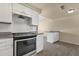 Kitchen with stainless steel oven, white cabinets, and granite countertops at 2545 E Amelia Ave, Phoenix, AZ 85016