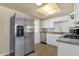 Bright kitchen with stainless steel appliances, white cabinets, and granite countertops at 2545 E Amelia Ave, Phoenix, AZ 85016