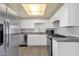 Bright kitchen with stainless steel appliances, white cabinets, and granite countertops at 2545 E Amelia Ave, Phoenix, AZ 85016