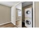 Laundry room features a stacked washer and dryer, closet, and wood floors at 2545 E Amelia Ave, Phoenix, AZ 85016