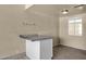 Utility bar area with light granite counters, storage, and a view of the sunlit window at 2545 E Amelia Ave, Phoenix, AZ 85016