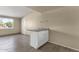 Utility bar area with light granite counters and storage by a window and doorway at 2545 E Amelia Ave, Phoenix, AZ 85016