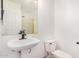 Modest bathroom featuring a pedestal sink, standard toilet, and plain fixtures at 2621 E Stottler Dr, Gilbert, AZ 85296