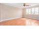 Spacious bedroom with hardwood floors, a ceiling fan, and natural light at 2621 E Stottler Dr, Gilbert, AZ 85296