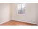 Cozy bedroom with wood floors and natural light from a single window at 2621 E Stottler Dr, Gilbert, AZ 85296
