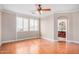 Large bedroom with hardwood floors, a ceiling fan, neutral walls, and bathroom access at 2621 E Stottler Dr, Gilbert, AZ 85296