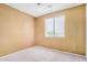 Bedroom with neutral carpet flooring and a large window overlooking the neighborhood at 2621 E Stottler Dr, Gilbert, AZ 85296