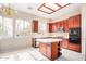 Spacious kitchen with cherry cabinets, an island, and ample natural light at 2621 E Stottler Dr, Gilbert, AZ 85296