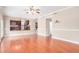 Expansive living area with hardwood floors, a view of the kitchen, and a classic ceiling fan at 2621 E Stottler Dr, Gilbert, AZ 85296