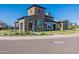 Clubhouse facade featuring stone accents, arched window and manicured landscaping at 2745 E Longhorn Dr, Gilbert, AZ 85297