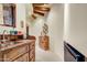 Hallway featuring granite countertops, wood cabinets, and unique architectural elements, adding character at 27903 N Agua Verde Dr, Rio Verde, AZ 85263