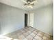 This bedroom has tile floors, a ceiling fan, and a door that opens to another room at 2912 E Monroe St, Phoenix, AZ 85034