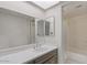 Bright bathroom featuring a large mirror, white countertop, and a shower-tub combo for added convenience at 331 S Beck Ave, Tempe, AZ 85281