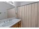 Cozy bathroom with a neutral-toned shower curtain, well-lit mirror, and traditional vanity for a soothing experience at 331 S Beck Ave, Tempe, AZ 85281