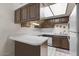 Efficient kitchen with white countertops, wood cabinetry, and essential appliances, offering functionality and style at 331 S Beck Ave, Tempe, AZ 85281