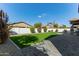 A backyard has manicured lawn, trees, privacy fence, and outdoor patio at 3344 E Grand Canyon Dr, Chandler, AZ 85249