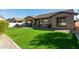 This backyard features an outdoor patio, manicured lawn, and privacy fence at 3344 E Grand Canyon Dr, Chandler, AZ 85249