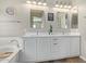 Bathroom with dual vanity sinks, framed mirrors, and a bathtub at 3344 E Grand Canyon Dr, Chandler, AZ 85249