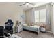 Cozy bedroom with carpet, a ceiling fan, and a window overlooking the backyard at 3344 E Grand Canyon Dr, Chandler, AZ 85249