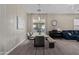 Bright dining area features a modern table, art, and string lights for a cozy and stylish gathering space at 3344 E Grand Canyon Dr, Chandler, AZ 85249