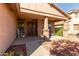 Inviting front porch with decorative wreath, charming seating, and manicured shrubbery at 3344 E Grand Canyon Dr, Chandler, AZ 85249