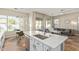 Open kitchen featuring white cabinets, stainless appliances, and views into the living area at 3344 E Grand Canyon Dr, Chandler, AZ 85249