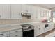 Kitchen with stainless steel appliances, white cabinets, and light countertops at 3344 E Grand Canyon Dr, Chandler, AZ 85249