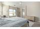 Bedroom with a light wood bed frame, neutral walls, and natural light from a large window at 3344 E Grand Canyon Dr, Chandler, AZ 85249