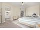 Bright bedroom featuring a gray carpet, a light wood dresser, and an entry to the ensuite bathroom at 3344 E Grand Canyon Dr, Chandler, AZ 85249