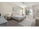 Bedroom with a light wood bed frame, neutral walls, and natural light from a large window at 3344 E Grand Canyon Dr, Chandler, AZ 85249