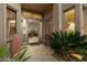 Inviting front entrance featuring desert landscaping, an open door and warm, neutral tones at 33705 N 64Th St, Scottsdale, AZ 85266