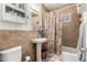 Traditional bathroom featuring a pedestal sink, tiled shower and a white toilet at 3834 N 32Nd Pl, Phoenix, AZ 85018