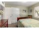 A well-lit bedroom features a classic wood sleigh bed with a view of a closet at 3834 N 32Nd Pl, Phoenix, AZ 85018