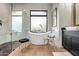 Luxurious bathroom with a freestanding tub, glass-enclosed shower, and elegant modern fixtures at 39705 N 3Rd St, Phoenix, AZ 85086