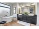 Luxurious bathroom featuring a soaking tub, double vanity, and stylish fixtures at 39705 N 3Rd St, Phoenix, AZ 85086
