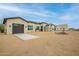 Spacious home exterior featuring a dark gray garage door and desert landscaping at 39705 N 3Rd St, Phoenix, AZ 85086