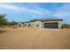 Exterior view of a modern home with multiple garage doors and a large front yard at 39705 N 3Rd St, Phoenix, AZ 85086