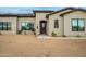 Elegant front door with desert landscaping, and a modern design featuring a neutral color palette at 39705 N 3Rd St, Phoenix, AZ 85086