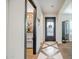 Bright hallway with decorative tile flooring leading to an ornate black front door and pantry at 39705 N 3Rd St, Phoenix, AZ 85086