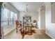Well-lit home office with wood desk, chandelier and plantation shutters for optimal productivity at 39705 N 3Rd St, Phoenix, AZ 85086