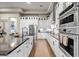 Modern kitchen equipped with stainless steel appliances, sleek white cabinetry, and stylish black countertops at 39705 N 3Rd St, Phoenix, AZ 85086